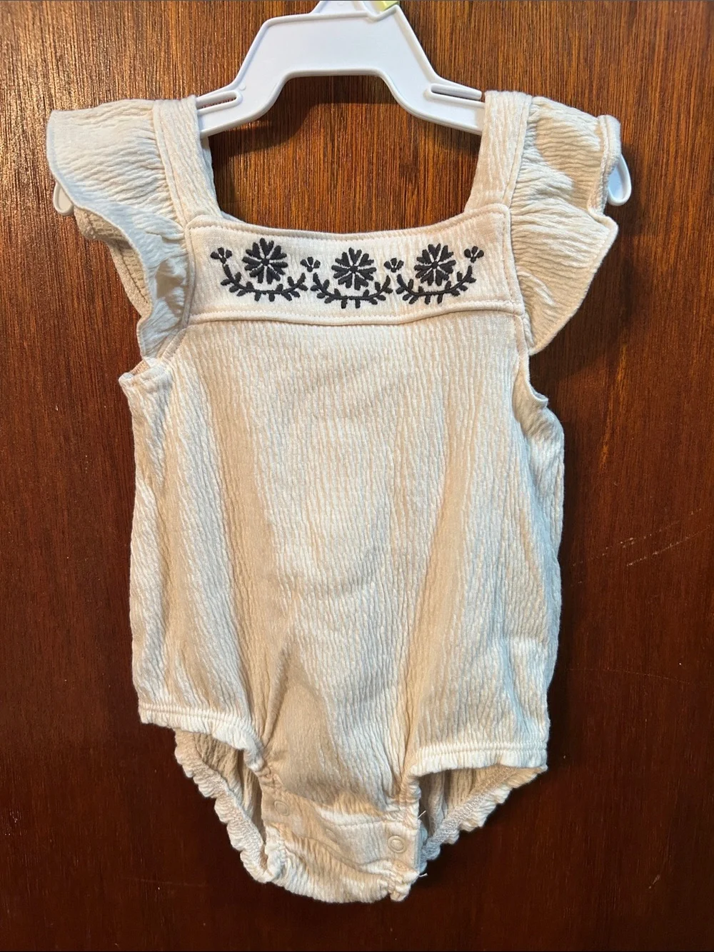 Cream Ruffle-Sleeve Baby One-Piece with Dark Grey Floral Embroidery